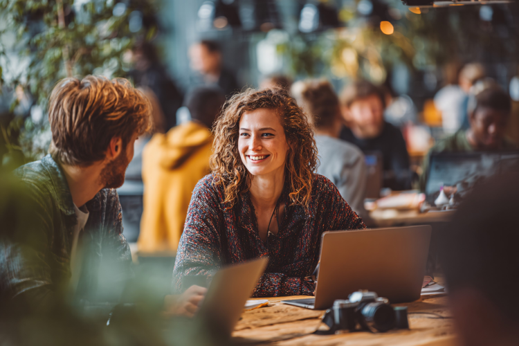 Woman Collaborating with Laptop at Table