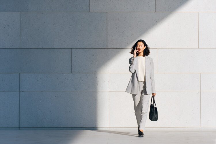 Businesswoman Talking on Phone Walking Outdoors Modern example image 1