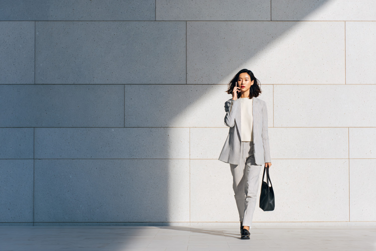 Businesswoman Talking on Phone Walking Outdoors Modern