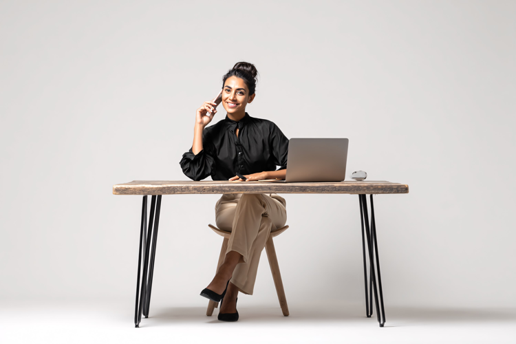 Woman Talking on Phone at Desk