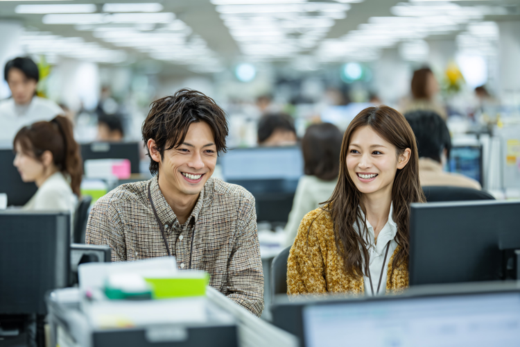 Young colleagues smiling and collaborating in a modern,