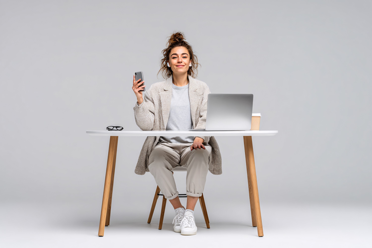 Young Woman with Laptop and Phone