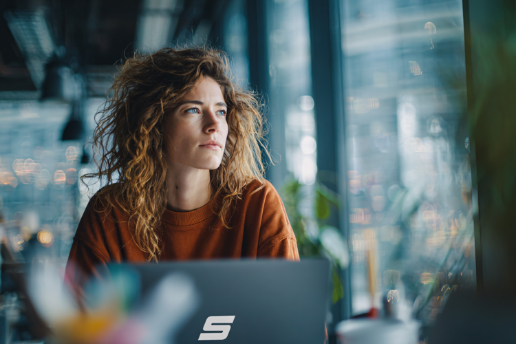 Thoughtful Woman Working by Window