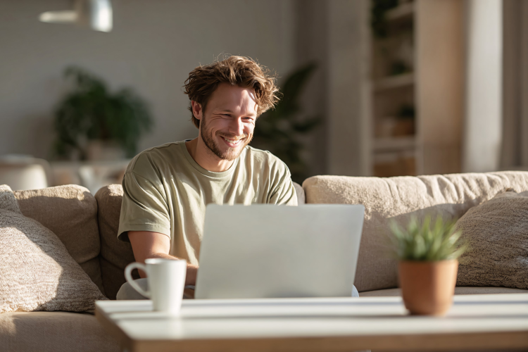 Man Working on Laptop on Home Couch