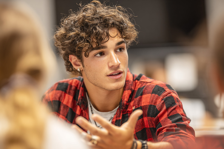 Young Man Gesturing During Discussion