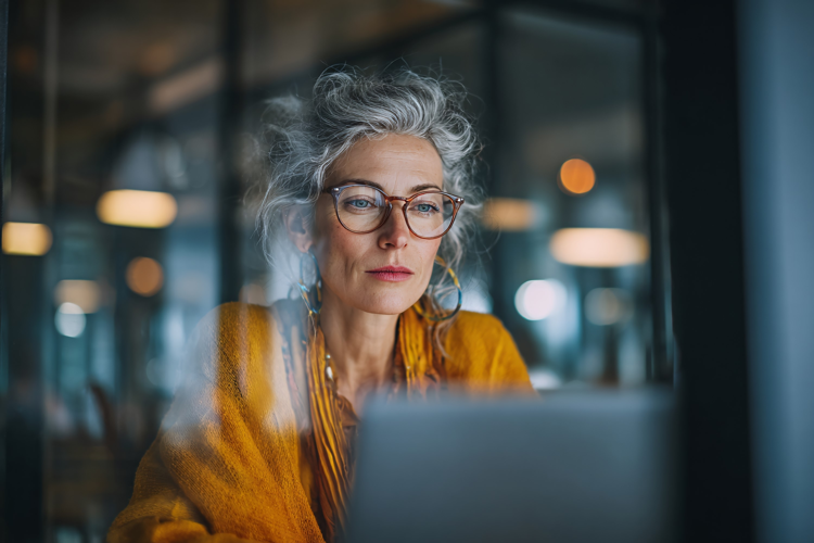 Mature Woman Working on Laptop in Office