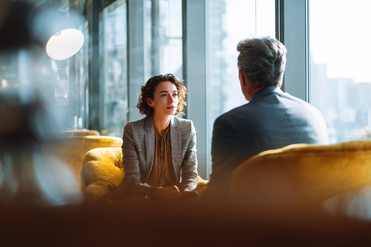 Business Professionals Talking by Windows