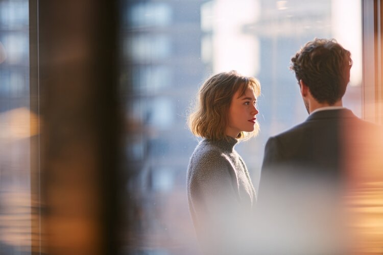 Colleagues Talking Near Office Window example image 1