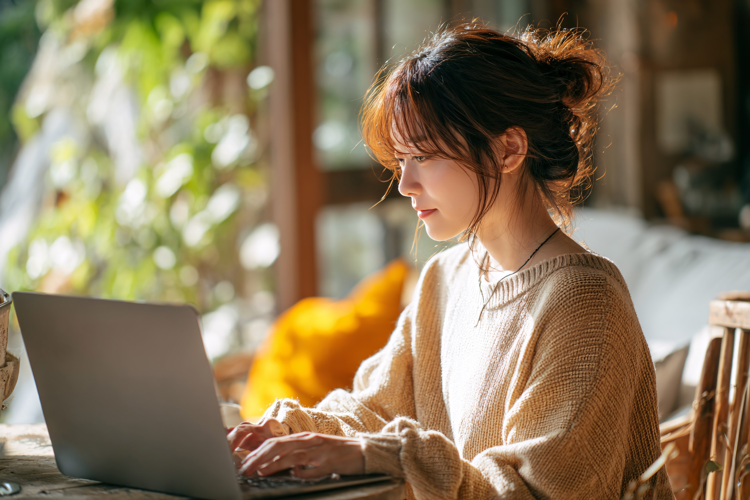 Woman Working on Laptop at Home