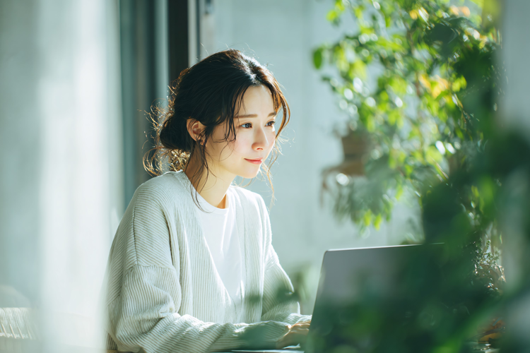 Woman Working on Laptop at Home