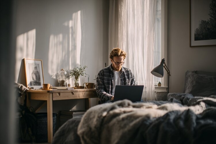 Man Working on Laptop in Cozy Home Office with Natural Light example image 1