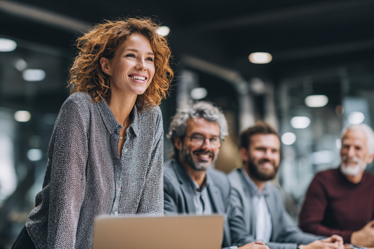 Smiling businesswoman leading team meeting, diverse colleagu