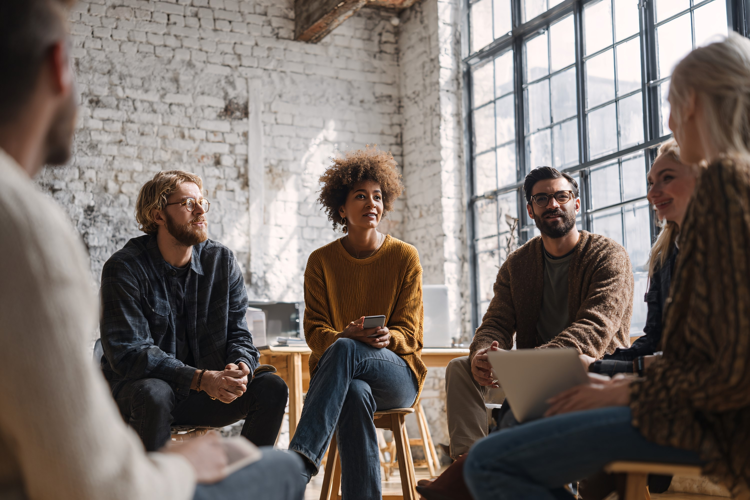Diverse team meeting in bright loft office, discussing ideas
