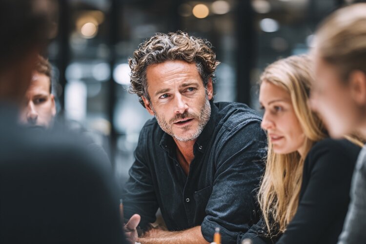 Diverse Business Team Collaborating in Modern Office Meeting example image 1