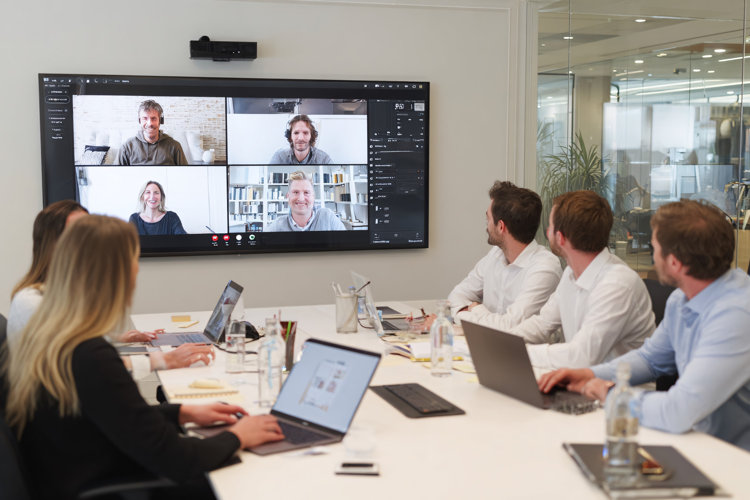 Team in Modern Office Attending Video Conference Meeting