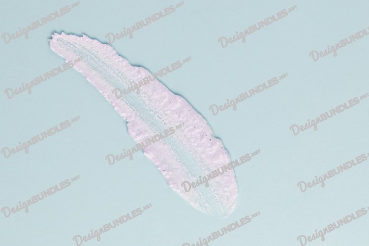 Smear of white cream for face and body on a blue background example image 1