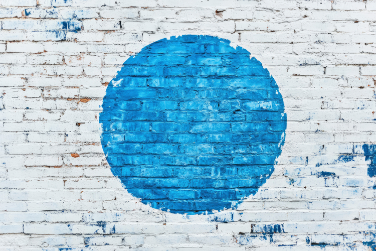 Blue Circle on a Brick Wall Background Wallpaper