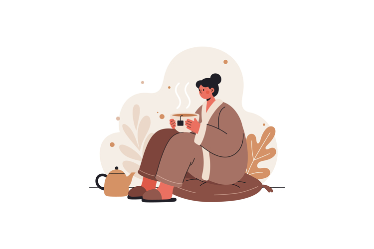 Woman in cozy bathrobe enjoying hot tea sitting on cushion w
