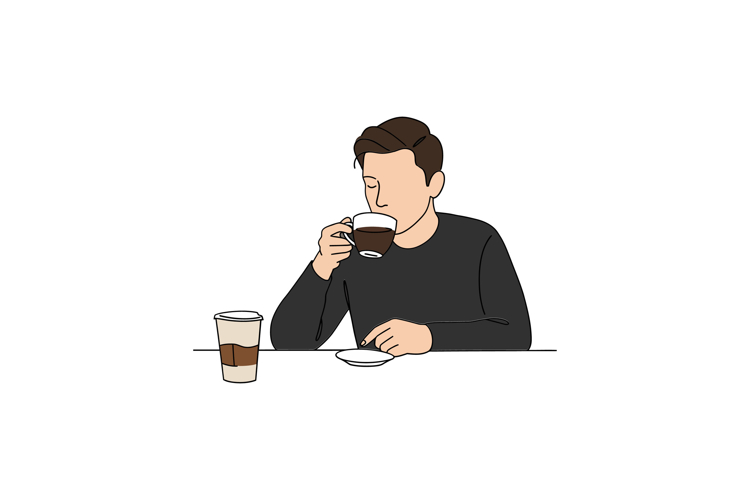 A man enjoying a cup of coffee while seated at a table in a