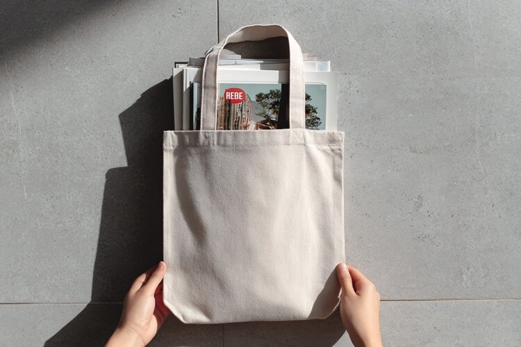 Canvas Tote Bag Held by Hands for Brand Showcase example image 1