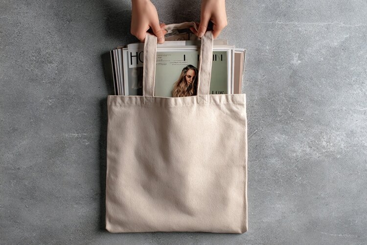 Beige Canvas Tote Bag with Magazines Inside example image 1